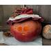 A candle lights the smile of this fall apple decoration. It is a real gourd with a happy face carved into it. This gourd is named Apple.